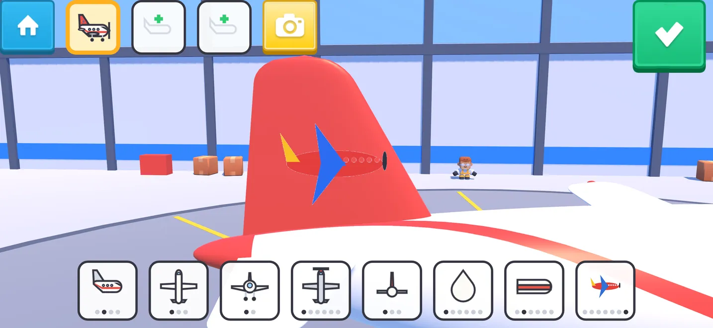 格納庫の飛行機。赤い尾翼にお子さんの絵が貼られている